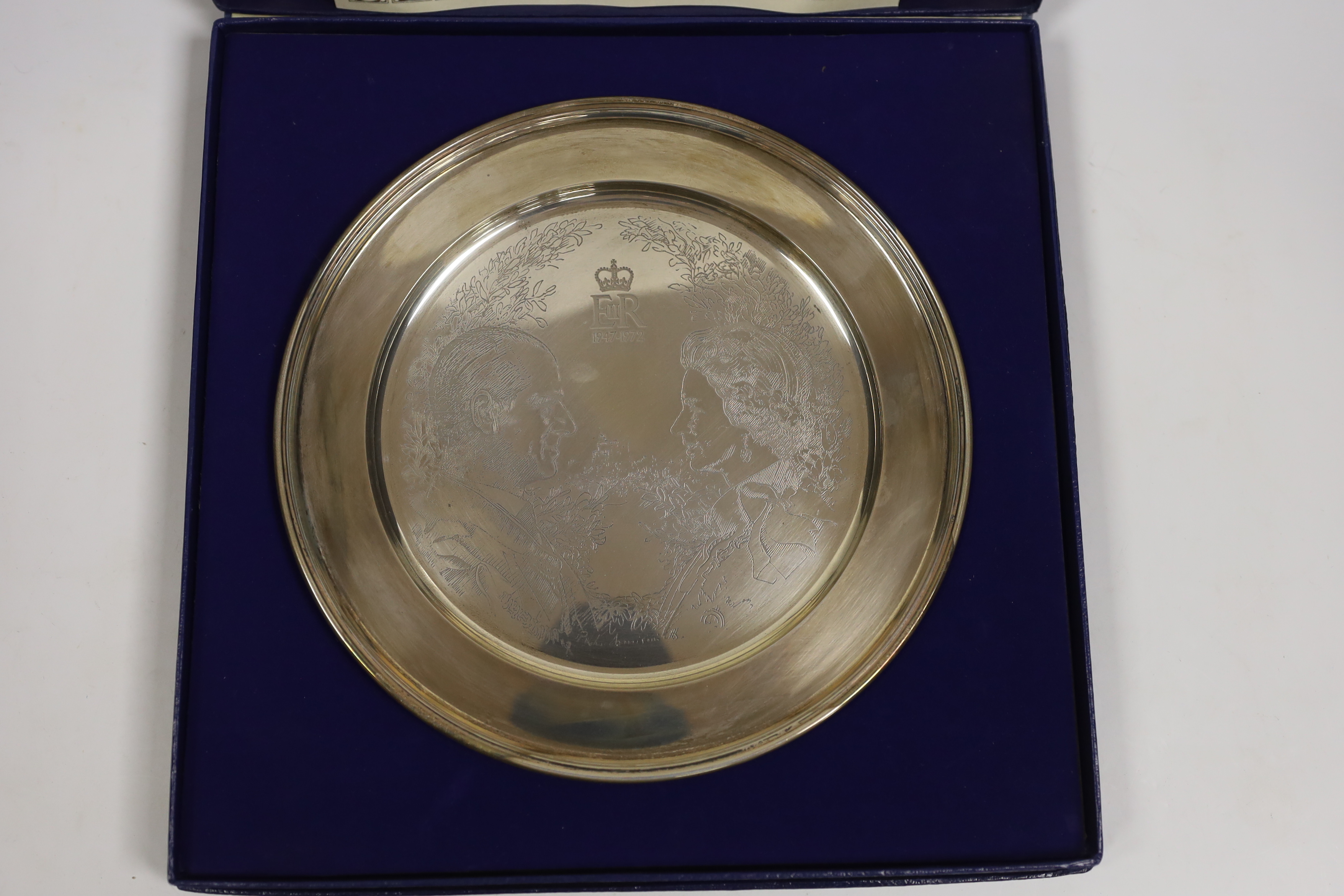 A cased limited edition silver plate commemorating the Silver Wedding of Queen Elizabeth II and H.R. Prince Philip, 1972, designed by Annigoni, William Comyns & Sons Ltd, London, 1972, diameter 22.8cm, 12.1oz.